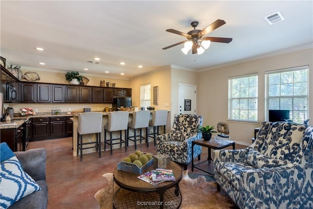 living room with ceiling fan and crown molding