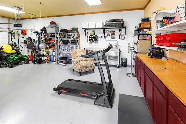 exercise room with a garage and a workshop area