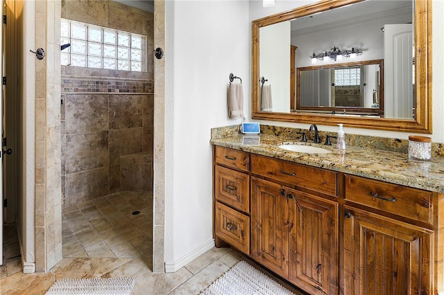 full bath featuring baseboards, walk in shower, and vanity