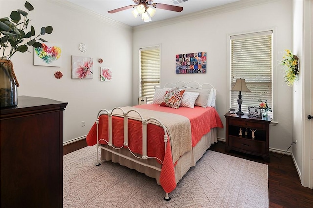 bedroom featuring visible vents, ornamental molding, a ceiling fan, wood finished floors, and baseboards