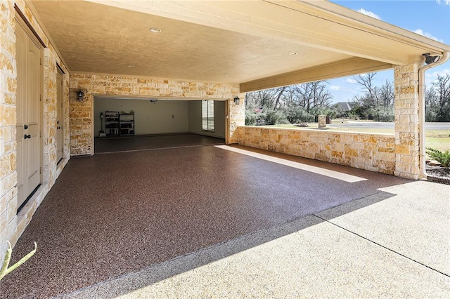 view of patio / terrace with a garage and aphalt driveway