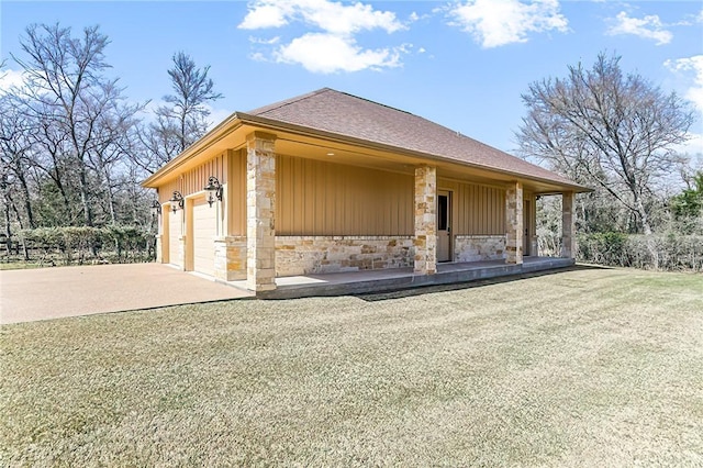 view of front of home featuring driveway, a shingled roof, stone siding, an attached garage, and board and batten siding