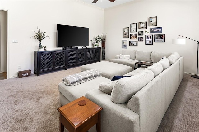 living area with crown molding, carpet, ceiling fan, and baseboards