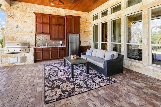 interior space with dark wood finished floors, tasteful backsplash, freestanding refrigerator, wood ceiling, and plenty of natural light