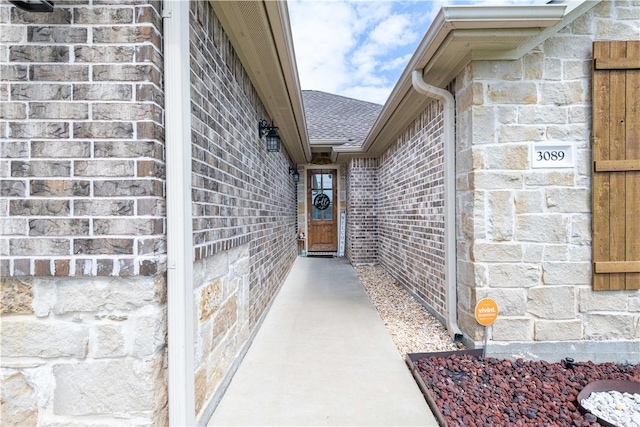 3089 Peterson Cir, Bryan, TX 77802 - property entrance with stone siding and roof with shingles