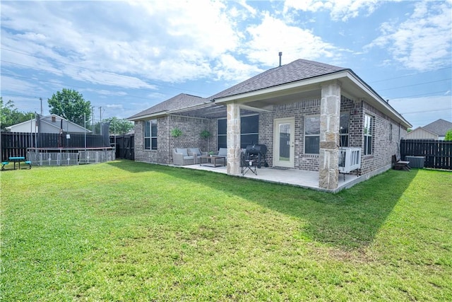 3089 Peterson Cir, Bryan, TX 77802 - rear view of house with a trampoline, a patio area, brick siding, and central AC unit