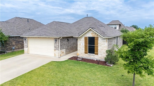 3089 Peterson Cir, Bryan, TX 77802 - view of front of home with stone siding, a front yard, a garage, driveway, and roof with shingles