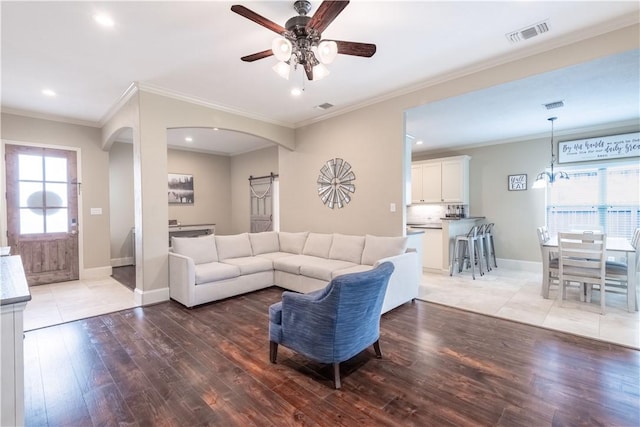 3089 Peterson Cir, Bryan, TX 77802 - living room featuring light wood finished floors, ceiling fan, arched walkways, recessed lighting, and baseboards