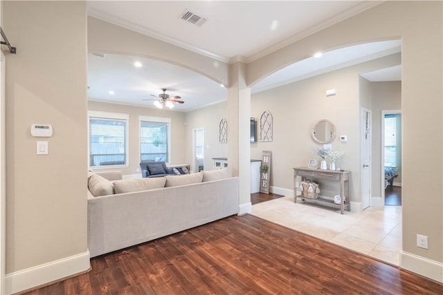 3089 Peterson Cir, Bryan, TX 77802 - living area with crown molding, a ceiling fan, wood finished floors, baseboards, and recessed lighting