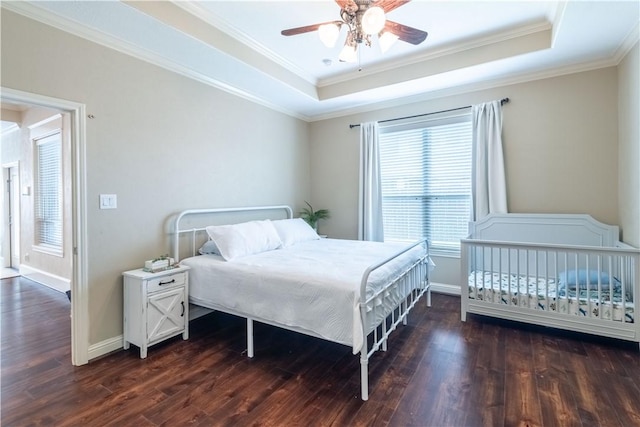 3089 Peterson Cir, Bryan, TX 77802 - bedroom featuring a raised ceiling, dark wood-style flooring, crown molding, and a ceiling fan