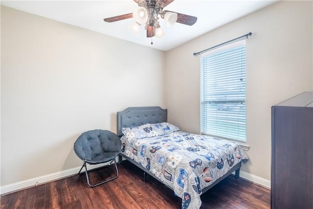 3089 Peterson Cir, Bryan, TX 77802 - bedroom featuring multiple windows, baseboards, wood finished floors, and ceiling fan