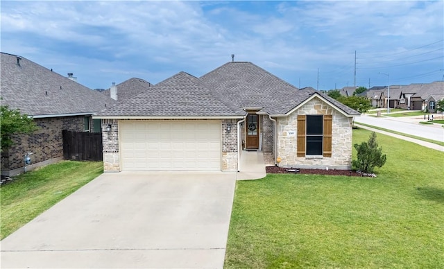 3089 Peterson Cir, Bryan, TX 77802 - view of front of property featuring stone siding, concrete driveway, a garage, and a shingled roof