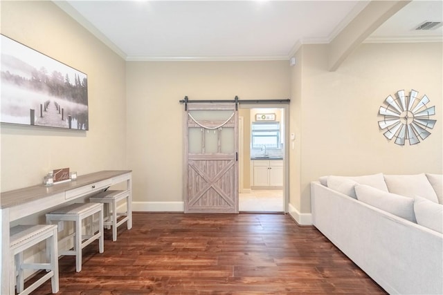 3089 Peterson Cir, Bryan, TX 77802 - office space featuring a barn door, wood finished floors, a sink, crown molding, and baseboards