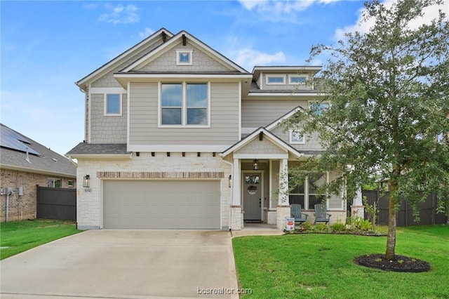 craftsman inspired home featuring a front lawn and a garage