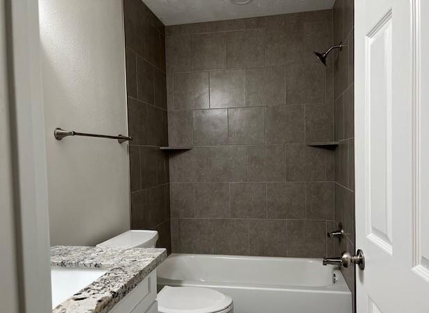 1207 N Houston Ave, Bryan, TX 77803 - bathroom with toilet, vanity, and bathtub / shower combination