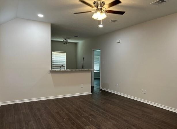 1207 N Houston Ave, Bryan, TX 77803 - unfurnished living room featuring dark wood finished floors, baseboards, a ceiling fan, and recessed lighting