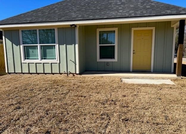 1207 N Houston Ave, Bryan, TX 77803 - doorway to property with roof with shingles and board and batten siding