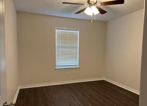 1207 N Houston Ave, Bryan, TX 77803 - unfurnished room featuring dark wood-style floors, baseboards, and a ceiling fan