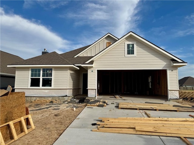 craftsman-style house with a garage, board and batten siding, and a shingled roof