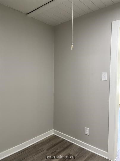 empty room featuring dark hardwood / wood-style flooring