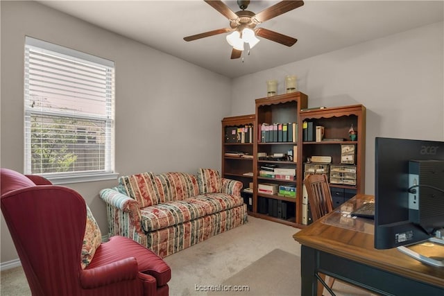 home office featuring ceiling fan and light carpet