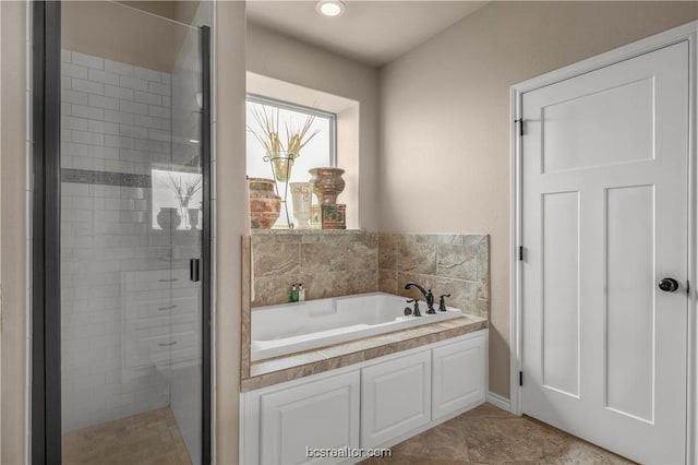 bathroom featuring tile patterned flooring and separate shower and tub