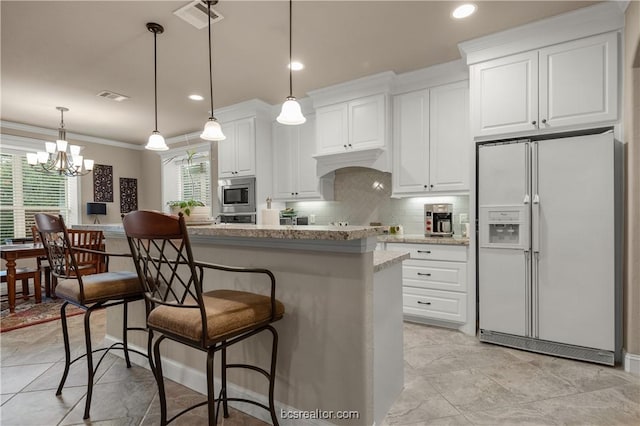 kitchen featuring white refrigerator with ice dispenser, stainless steel microwave, white cabinetry, and a wealth of natural light