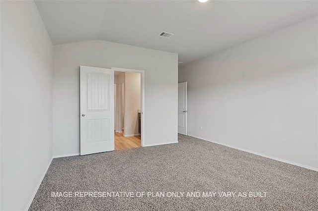 103 Comal Dr, Huntsville, TX 77340 - unfurnished bedroom featuring carpet flooring and vaulted ceiling