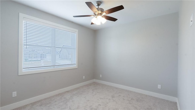 empty room featuring light carpet and ceiling fan