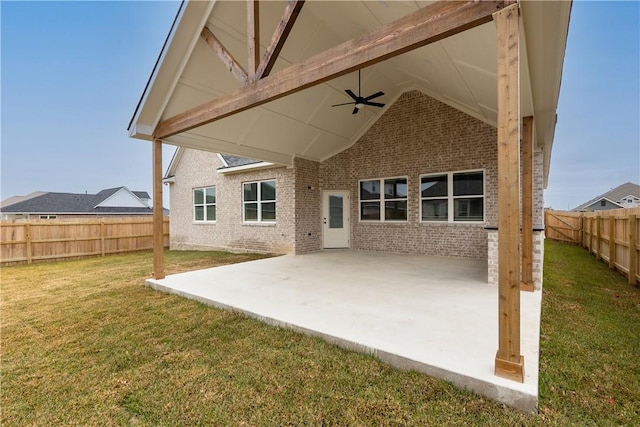 back of property with a yard, a patio, and ceiling fan