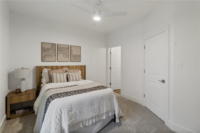 carpeted bedroom featuring baseboards and ceiling fan