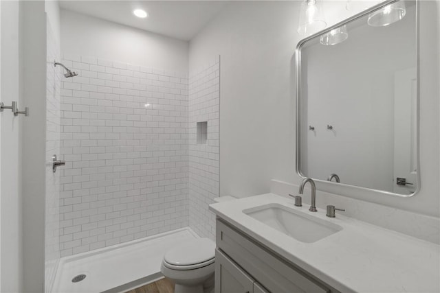 full bathroom with vanity, toilet, a shower stall, and recessed lighting