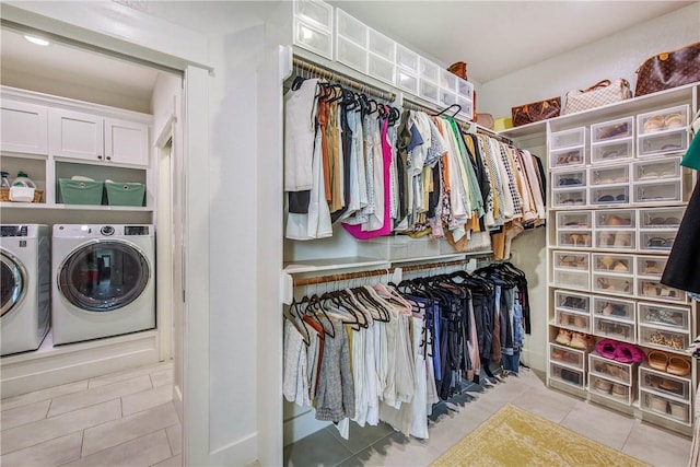 walk in closet featuring light tile patterned floors and washing machine and dryer