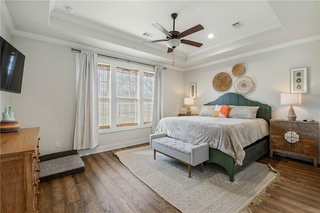 bedroom with a raised ceiling, ceiling fan, and ornamental molding