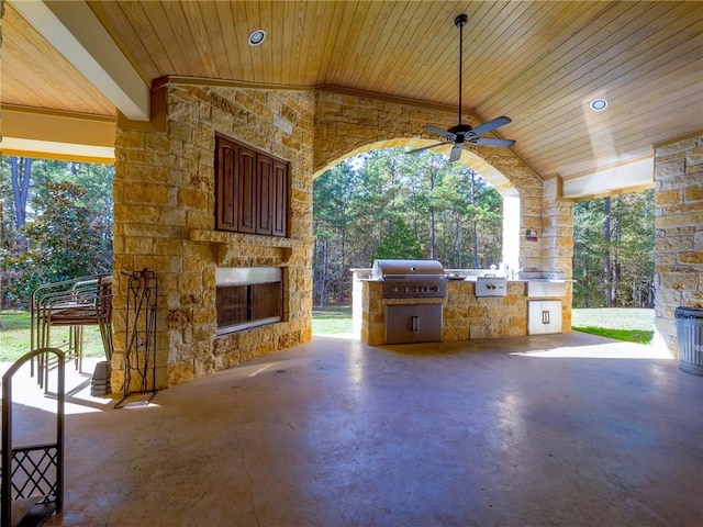 1142 Fletcher, Anderson, TX 77830 - view of patio with an outdoor stone fireplace, exterior kitchen, and a ceiling fan