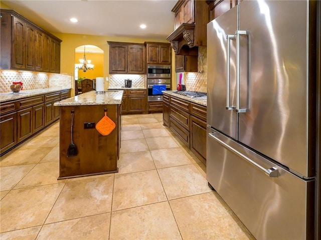1142 Fletcher, Anderson, TX 77830 - kitchen with stainless steel appliances, tasteful backsplash, a kitchen island, a chandelier, and recessed lighting