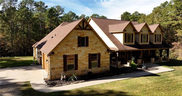 1142 Fletcher, Anderson, TX 77830 - view of front facade with stone siding, driveway, a front lawn, and a porch
