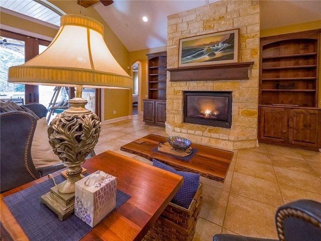 1142 Fletcher, Anderson, TX 77830 - living area featuring built in features, light tile patterned floors, a stone fireplace, ceiling fan, and vaulted ceiling