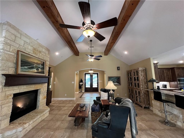 1142 Fletcher, Anderson, TX 77830 - living room featuring arched walkways, ceiling fan, and a fireplace