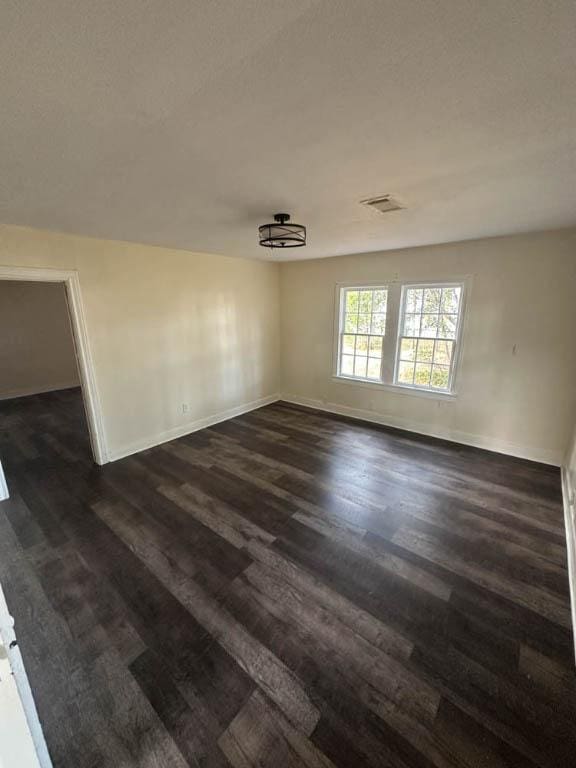 spare room featuring dark hardwood / wood-style flooring