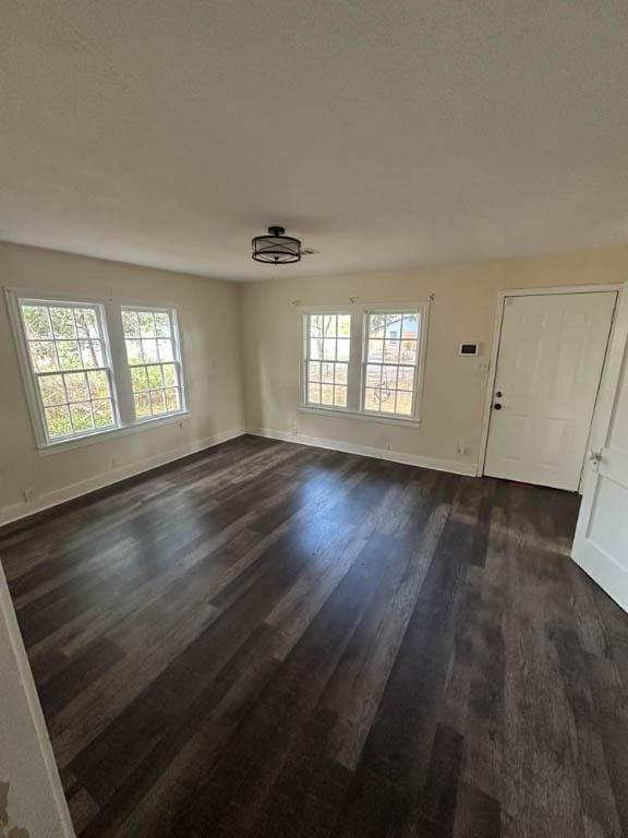 interior space featuring dark hardwood / wood-style floors and plenty of natural light