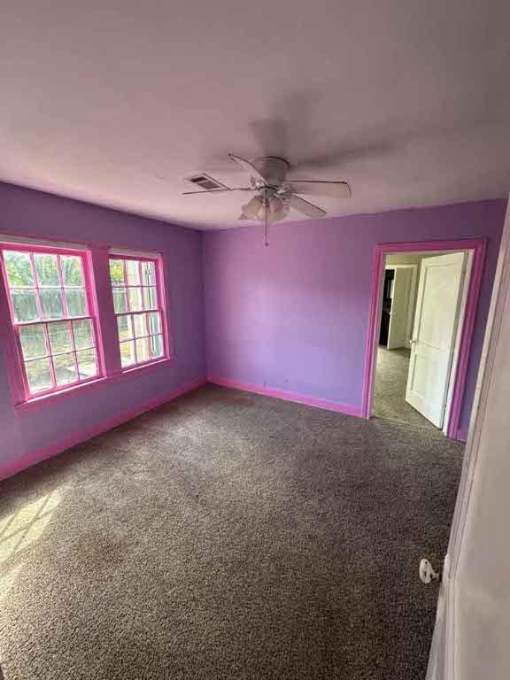 spare room featuring carpet flooring and ceiling fan