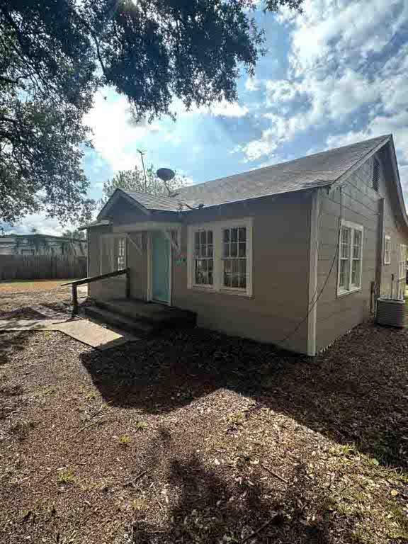 rear view of property with central AC unit