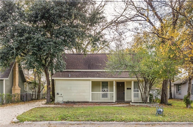 view of front of house with covered porch and a front yard