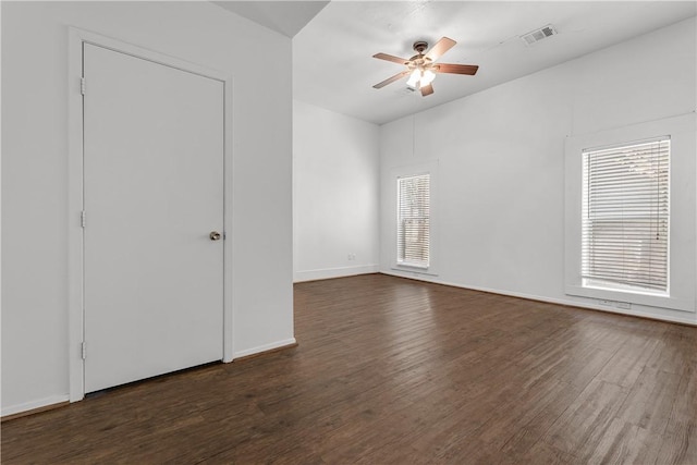 spare room with ceiling fan and dark hardwood / wood-style floors