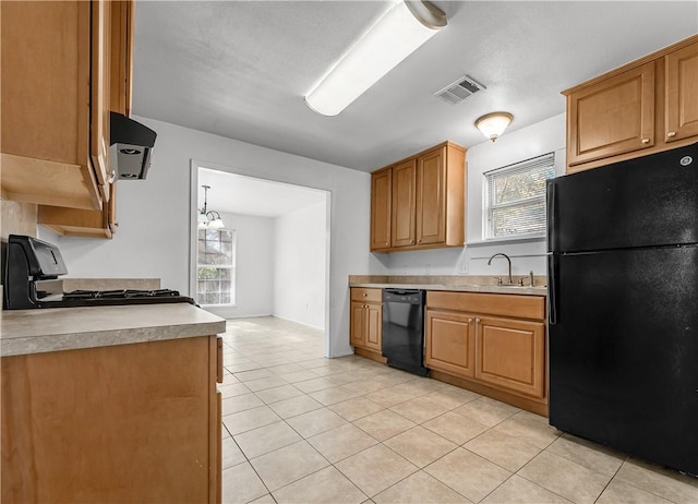 kitchen featuring sink, black appliances, plenty of natural light, and extractor fan