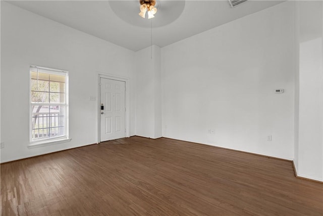 unfurnished room featuring ceiling fan and dark hardwood / wood-style floors