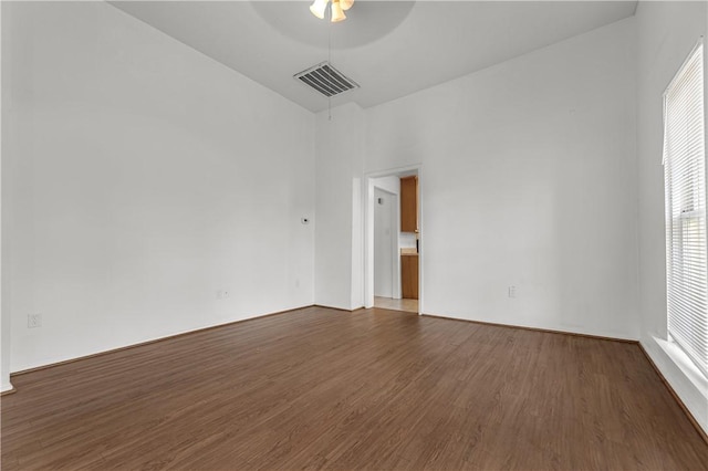 unfurnished room featuring ceiling fan and dark hardwood / wood-style flooring