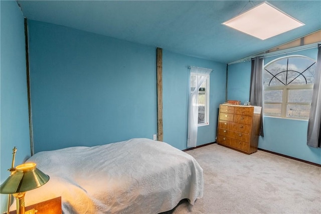 bedroom featuring light carpet and baseboards