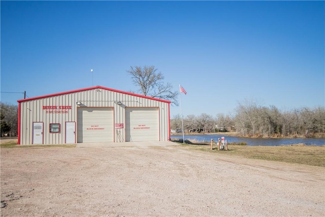 detached garage with a water view